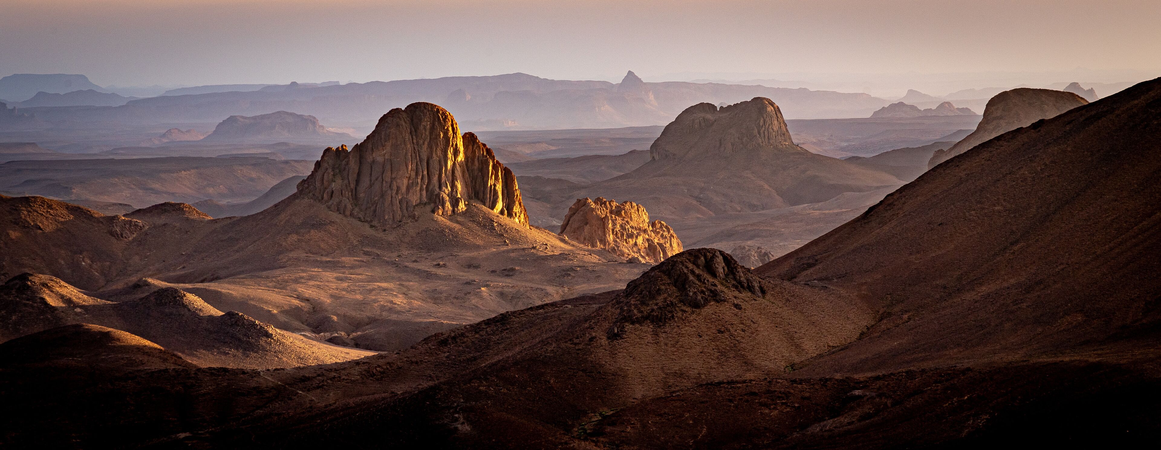 Hoggar landscape in the Sahara desert, Algeria. A view of the mountains and basalt organs that stand around the dirt road that leads to Assekrem.