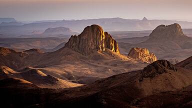 Hoggar landscape in the Sahara desert, Algeria. A view of the mountains and basalt organs that stand around the dirt road that leads to Assekrem.