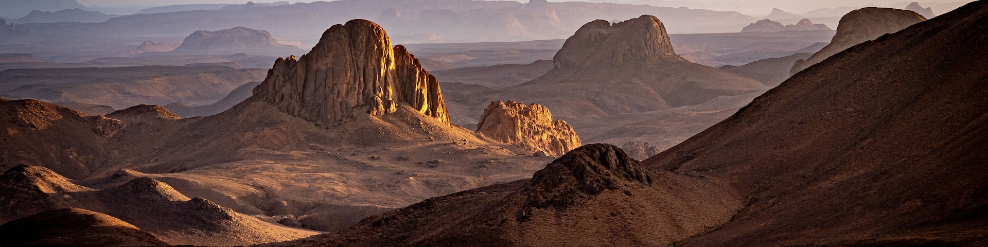 Hoggar landscape in the Sahara desert, Algeria. A view of the mountains and basalt organs that stand around the dirt road that leads to Assekrem.