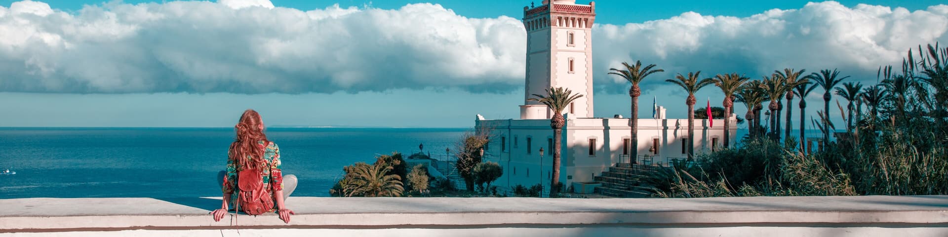Woman tourist looking at lighthouse of Cap Spartel, Tanger, Morocco in Africa