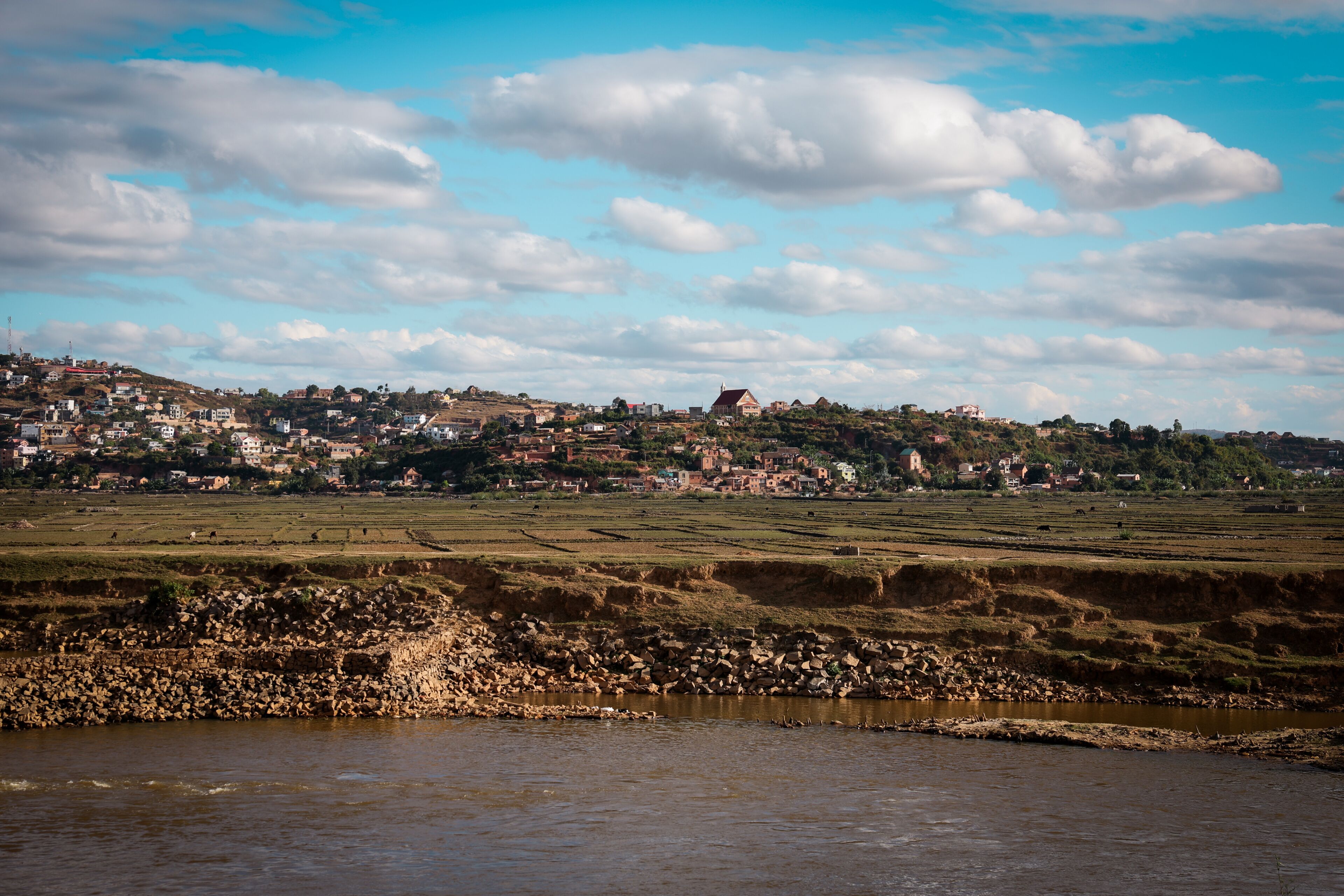 Landscape view of rural fields and hills in the suburb of Antananarivo, Madagascar under a cloudy sky