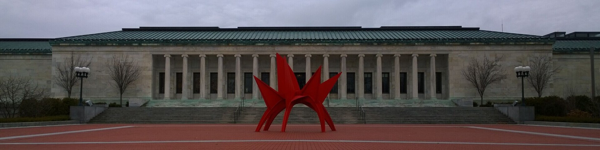 Opened in 1912, the Toledo Museum of Art’s Greek Ionic façade has graced the city as both landmark and legacy. The distinguished low and horizontal white marble building is articulated by a row of 16 columns, a copper roof, and a frieze of acanthus leaves. It has been renovated and expanded four times since then.