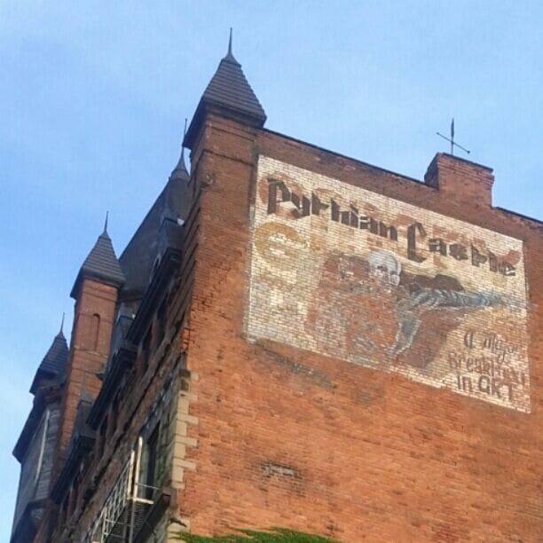 A mural painted on the side of the Pythian Castle that reads "A major breakthrough in art." The building was built in 1890 and has been vacant since the 1970's.