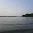 A view out into Maumee Bay from the endpoint of the 3/4 mile peninsula at Cullen Park, the westernmost point of Lake Erie.
Depending on the water level, the peninsula can be reduced to being not much wider than just the path. As you reach the tip of the peninsula, it widens out into a small sandy beach.
As a kid, I would return home from walking the peninsula with pockets full of sand worn smooth beach glass of all different colors that I still have to this day.