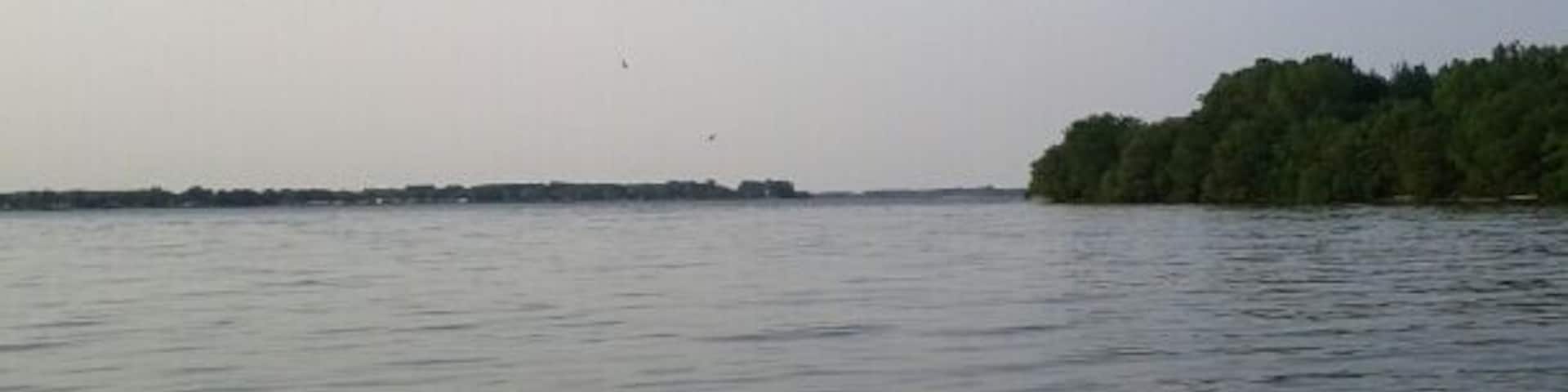 A view out into Maumee Bay from the endpoint of the 3/4 mile peninsula at Cullen Park, the westernmost point of Lake Erie. 
Depending on the water level, the peninsula can be reduced to being not much wider than just the path. As you reach the tip of the peninsula, it widens out into a small sandy beach. 
As a kid, I would return home from walking the peninsula with pockets full of sand worn smooth beach glass of all different colors that I still have to this day.