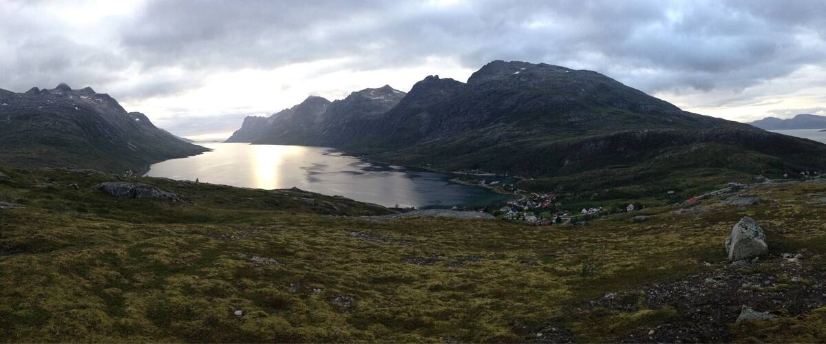 A mountainous landscape with a lake surrounded by rugged peaks.