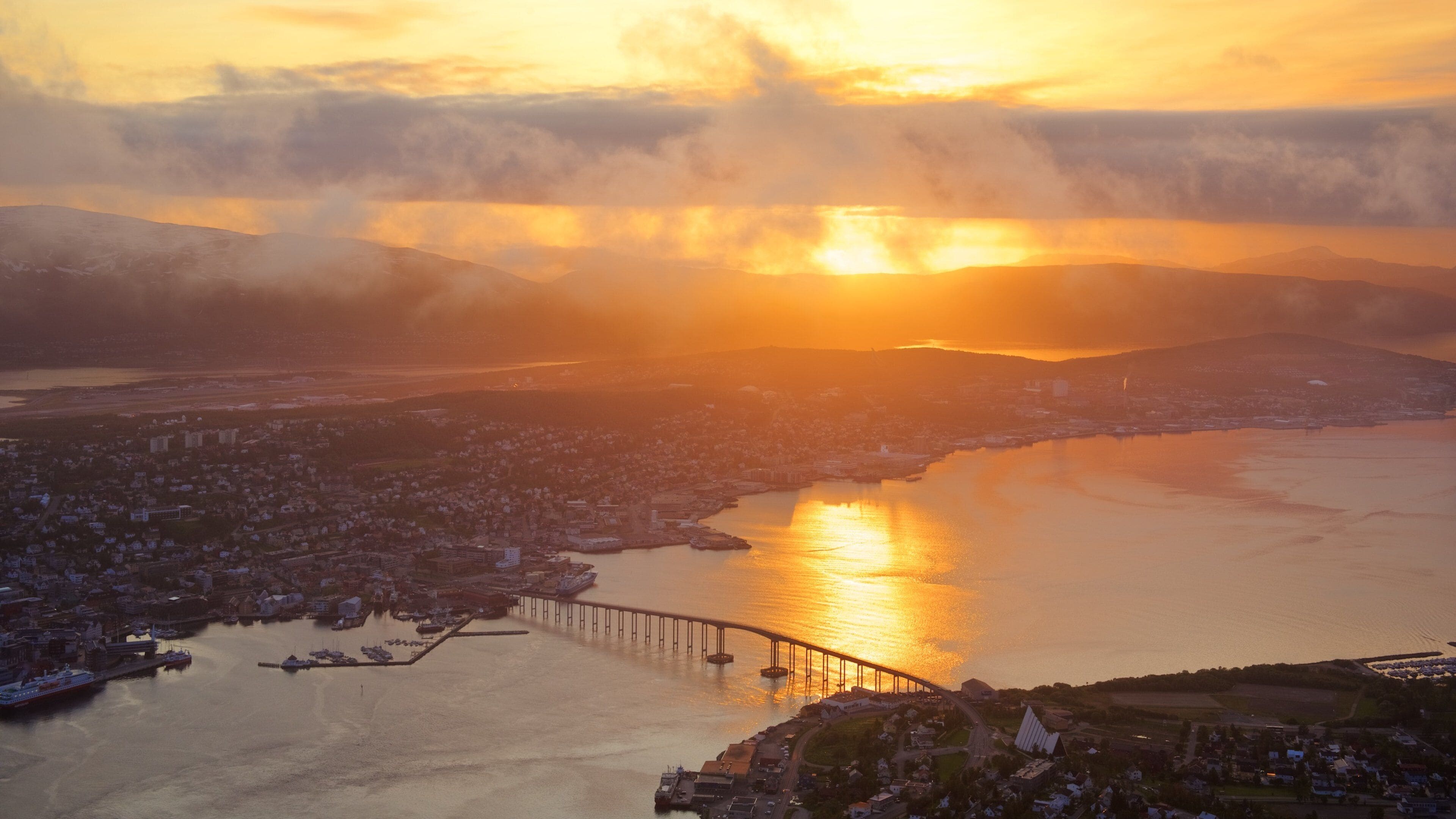 Tromso featuring a lake or waterhole, a sunset and a small town or village