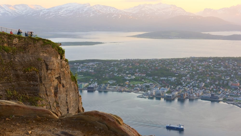 Tromso which includes a small town or village, a sunset and a lake or waterhole