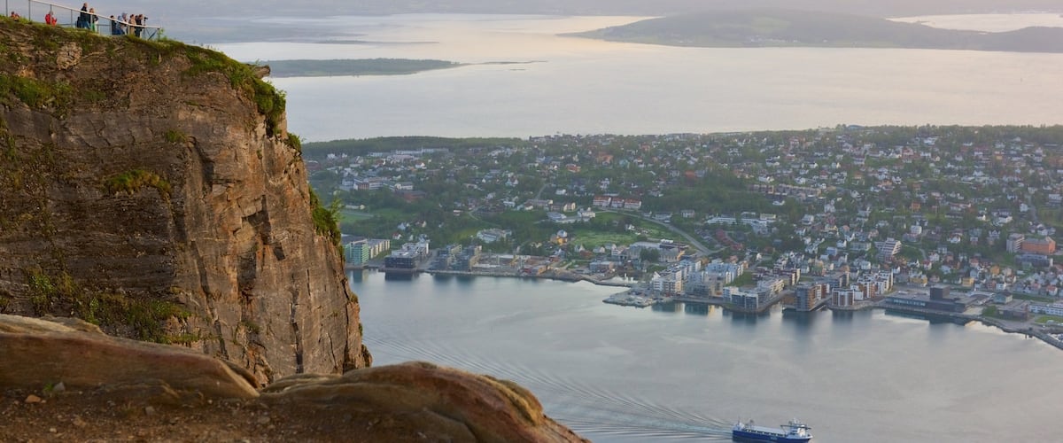 Tromso featuring a small town or village, a lake or waterhole and a sunset