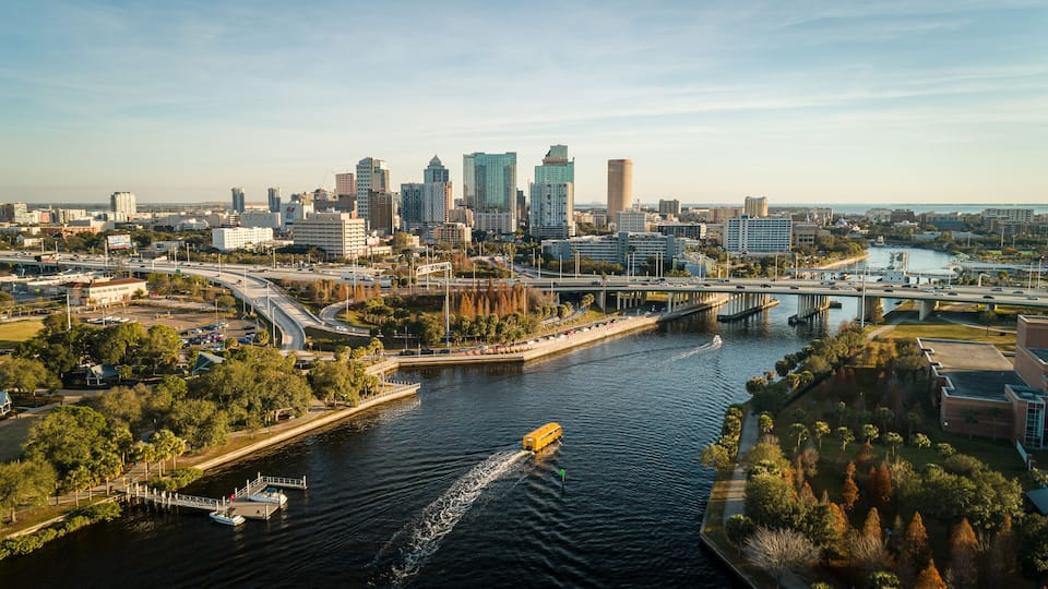 A cityscape with a river, bridges, and high-rise buildings.