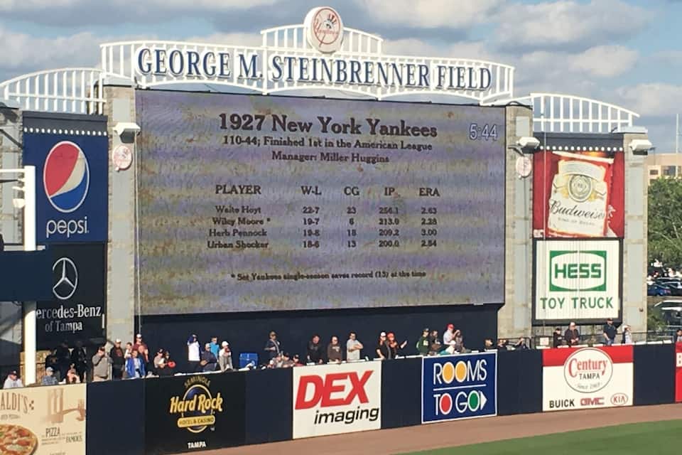 A baseball scoreboard at George M. Steinbrener Field with ads for Pepsi, Mercedes-Benz, Hard Rock, DEX Imaging, Century Tampa, and Hess Toy Truck.