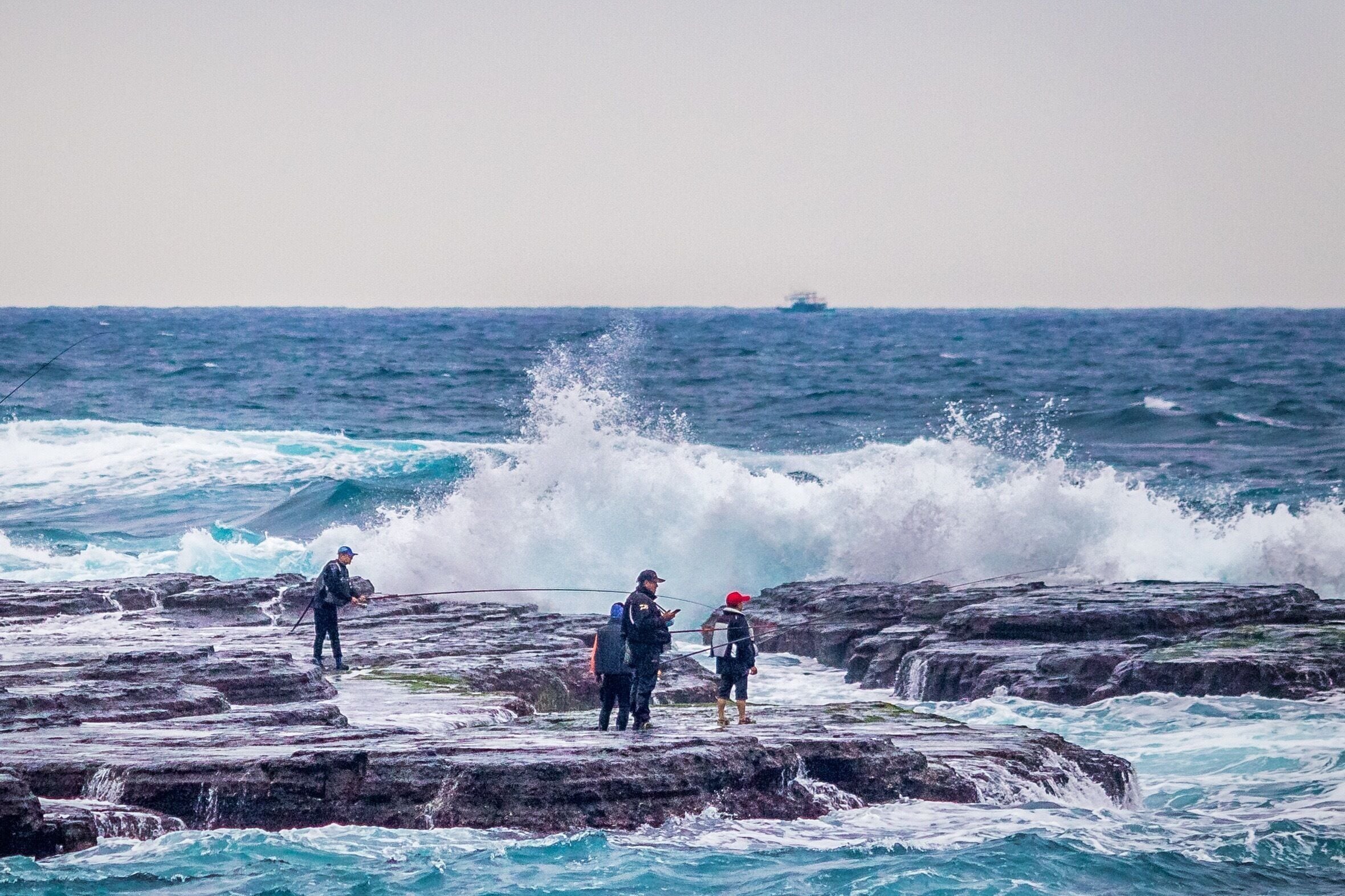 Fishing and cell phone checking amongst the waves along Taiwan’s far NE coast. It’s a windswept and geologic landscape that look and feels like it could be the edge of the North Sea.