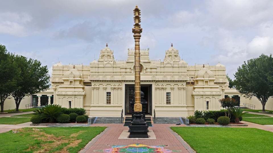 A temple with a central spire and a colorful floor design.