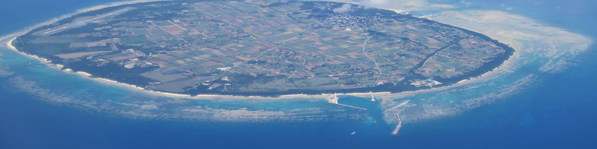 Aerial view of Tarama Island surrounded by coral reefs near Miyakojima, Okinawa, Japan