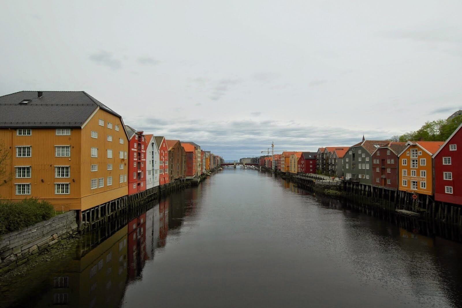 A canal lined with colorful buildings reflecting in the water.