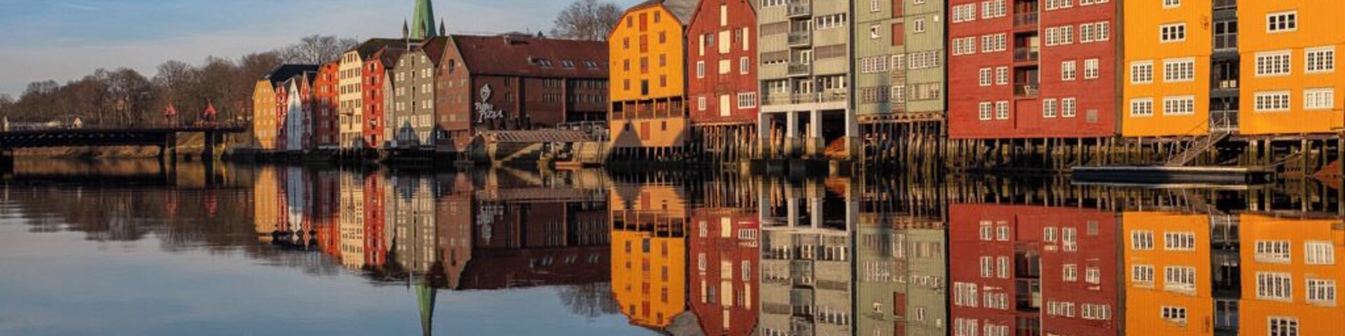 Trondheim is a city on the Trondheim Fjord, in central Norway. This is a beautiful location near the Bakke Bru Bridge overlooking and old part of town with building built on wooden stilts.