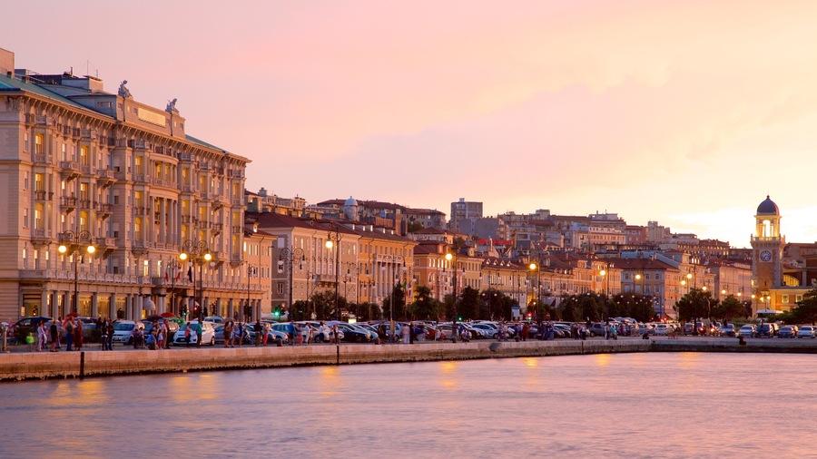 Trieste featuring general coastal views, a sunset and heritage architecture