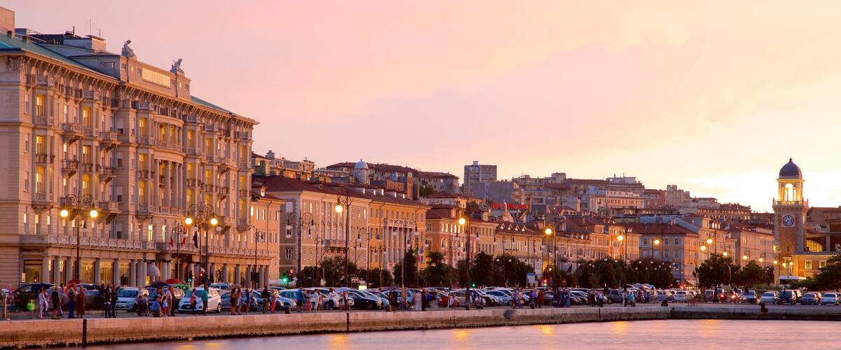 A waterfront cityscape with historic buildings and a prominent clock tower.