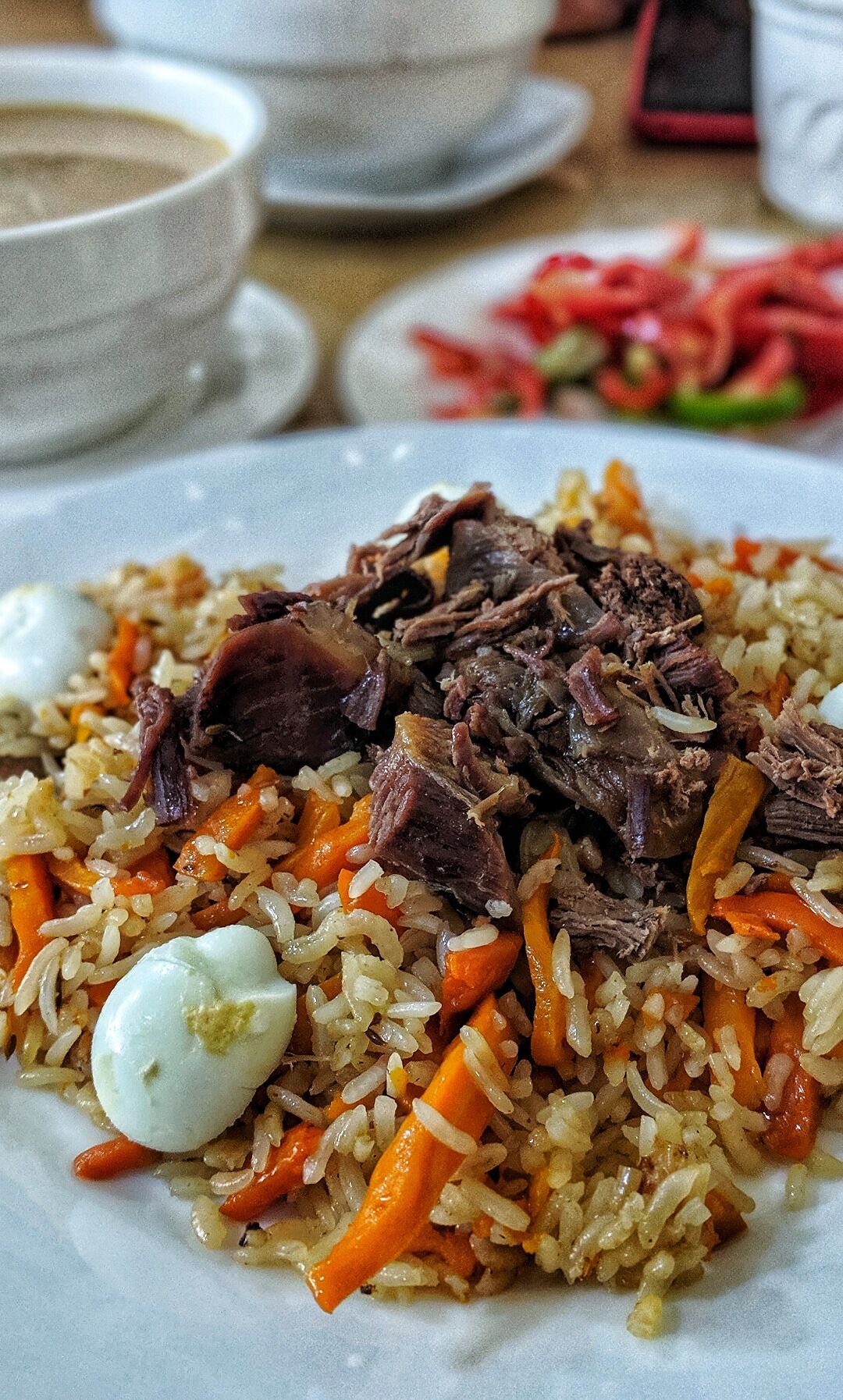 Uzbek Plov: a delicious mix of rice, meat, carrots, (quail eggs!) and spices cooked over an open fire until the bottom layer caramelizes and becomes crispy. Every bite is savory and followed by a bite of traditional bread baked in an outdoor underground stone oven 🌾
#centralasia #yum #eat