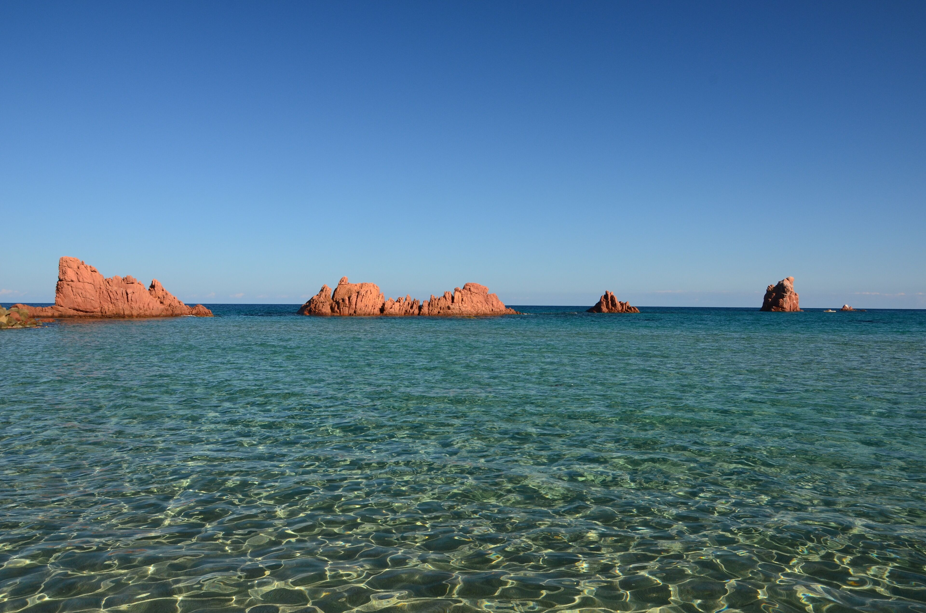 Is Scoglius Arrubius (sardinian; it. “gli scogli rossi”, en.: “the red rocks”) at the Marina di Cea