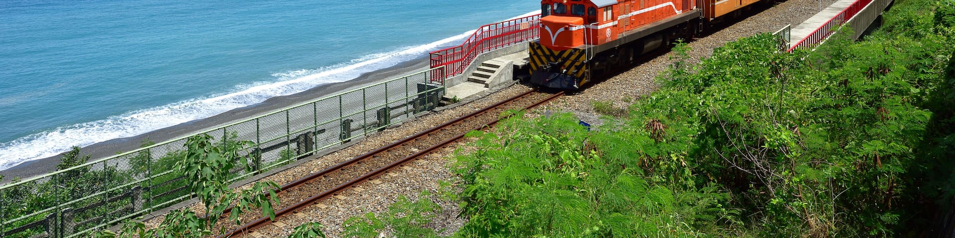 Taitung City, Taiwan, the train traveling along the coastline, a clear blue sky and white clouds and the ocean is a beautiful picture.; Shutterstock ID 773503573; purchase_order: SF 06557000; job: ; c