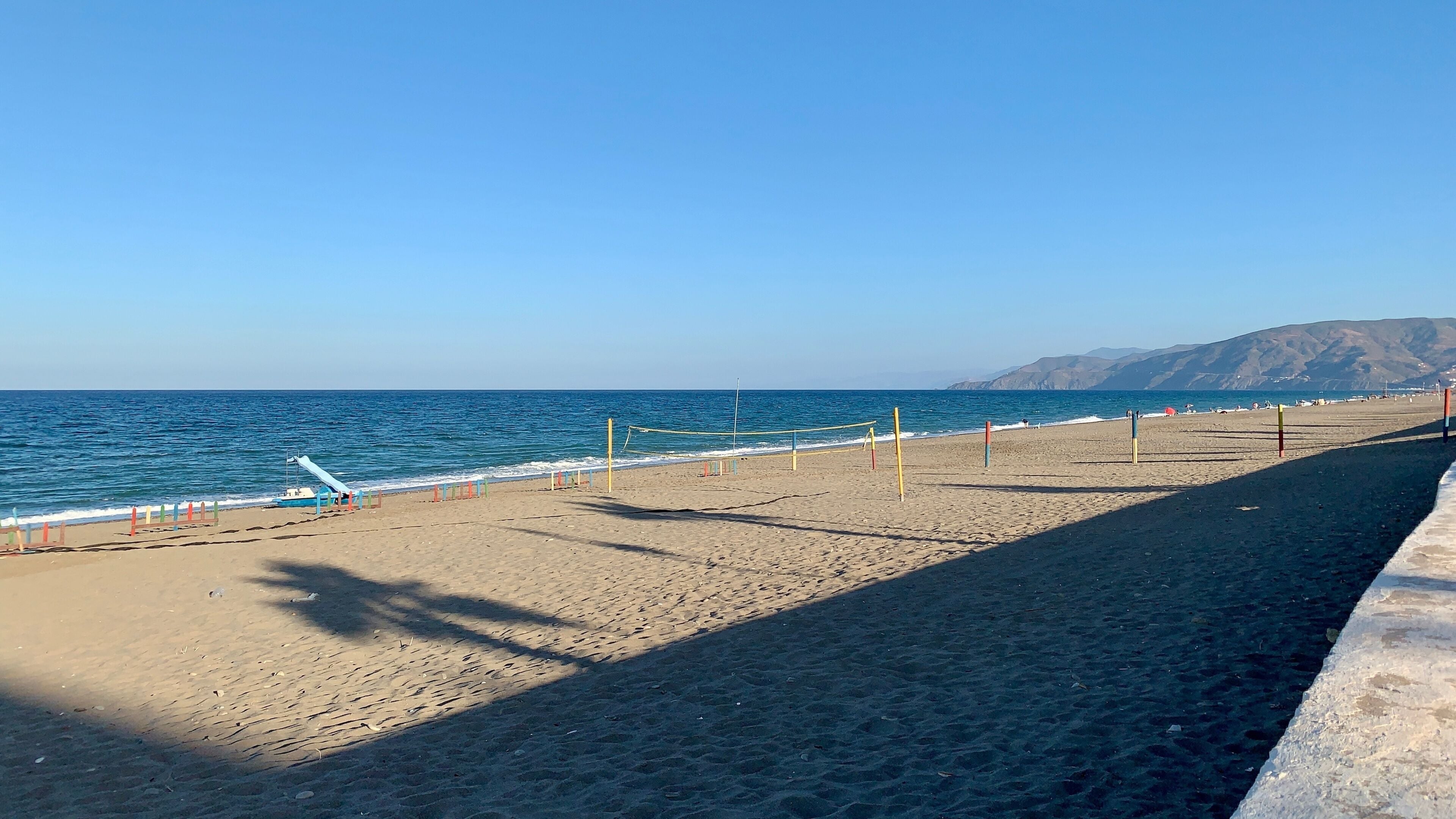 Explore Oued Laou Beach, featuring golden sands, colorful volleyball nets, and stunning ocean views. A perfect destination for relaxation, beach activities, and seaside adventures in Morocco.