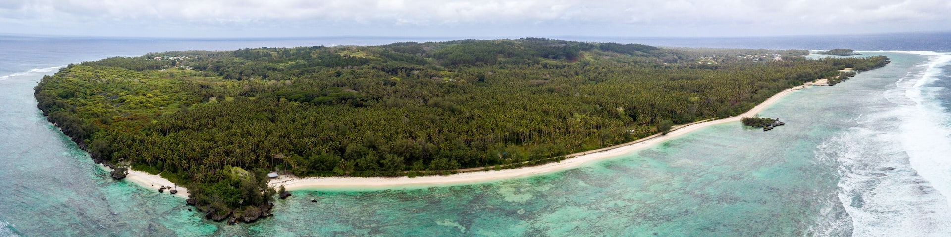 Aerial view of Rimatara island with yellow sandy beaches in azure turquoise blue waters. Tubuai Islands (Austral Islands), French Polynesia, Oceania.
