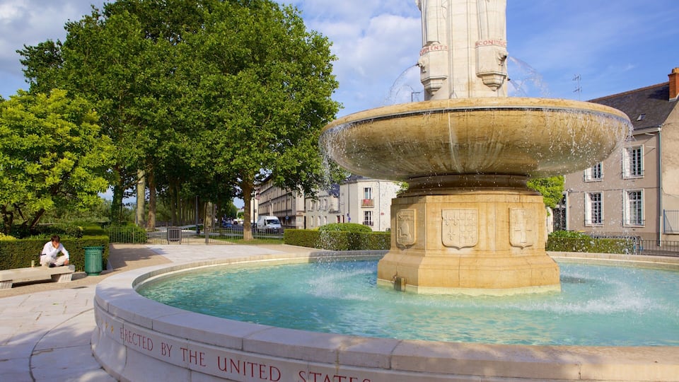 A fountain with water jets, surrounded by a circular pool, and a plaque reading "Erected by the United States."