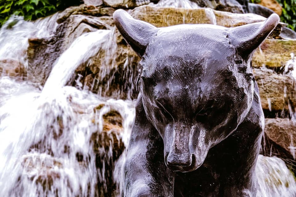 A sculpture of bears on a rocky waterfall.