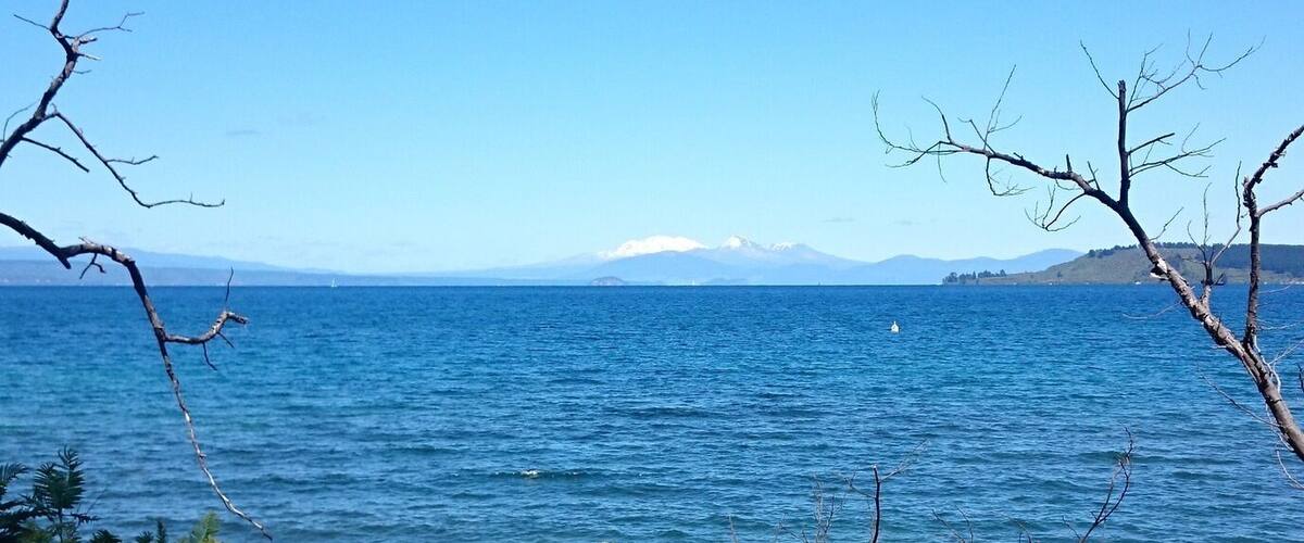 Looking out across Lake Taupo at the Central North Island volcanoes, Mount Ruapehu, Mount Ngauruhoe, and Mount Tongariro. The town of Taupo is very nice, with plenty of cheap hostels, around $25-35 per night