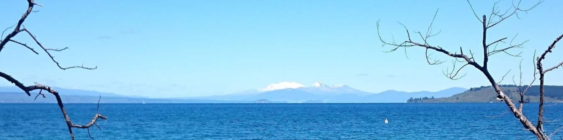 Looking out across Lake Taupo at the Central North Island volcanoes, Mount Ruapehu, Mount Ngauruhoe, and Mount Tongariro. The town of Taupo is very nice, with plenty of cheap hostels, around $25-35 per night