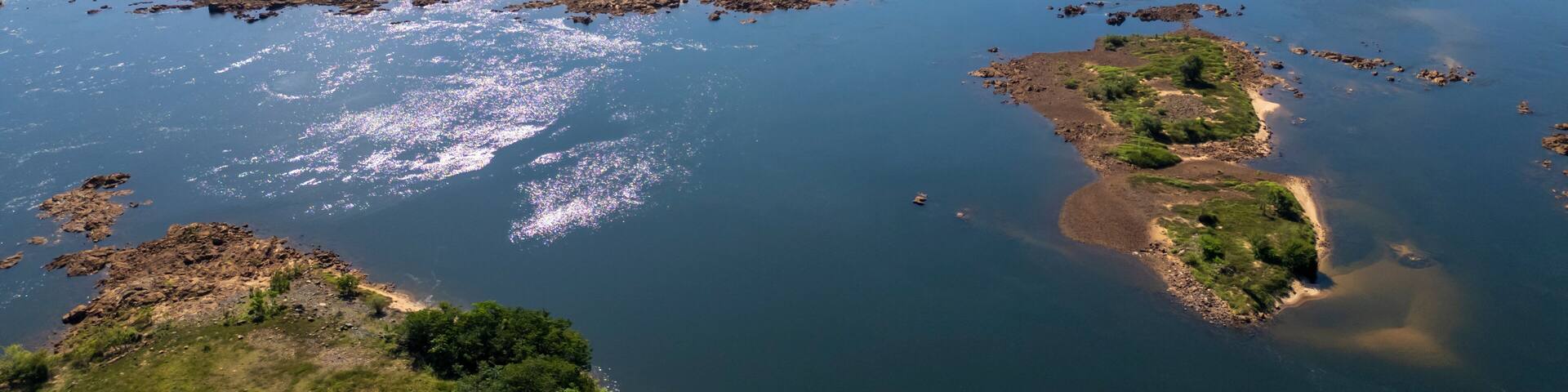 Aerial drone view showing prominent rock outcrops in the bed of the Tocantins river, located just downstream from the Tucurui hydroelectric power plant dam in Para, Brazil