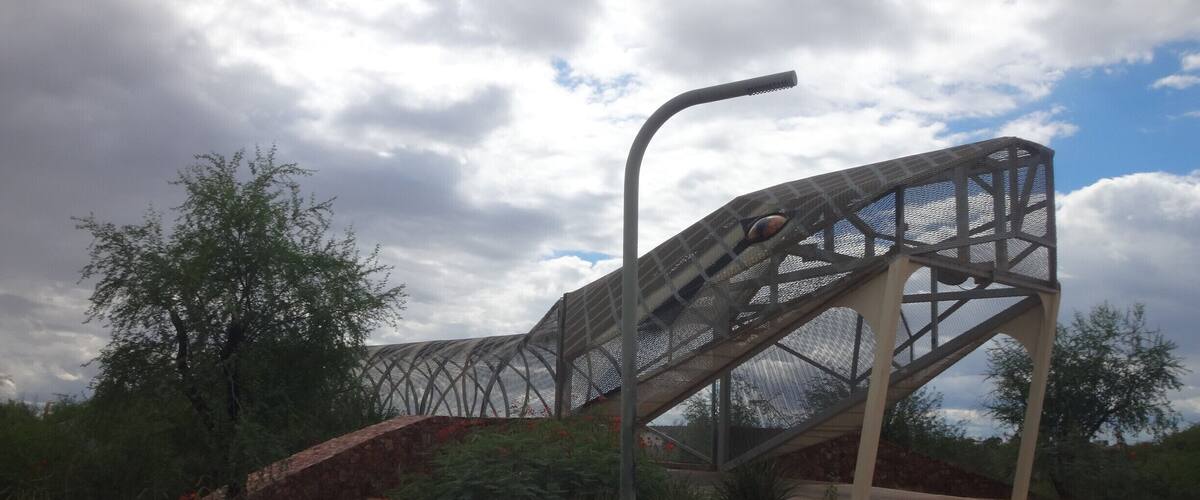 Unique pedestrian bridge. It continues on to the other side of the road, where its rattle rises up out of the sidewalk.