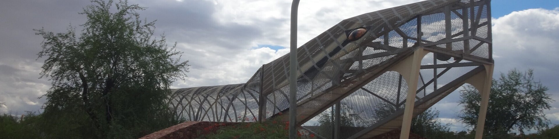 Unique pedestrian bridge. It continues on to the other side of the road, where its rattle rises up out of the sidewalk.