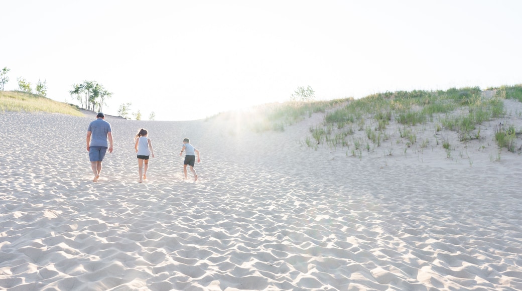 Family climbing Sleeping Bear Dunes at Sunset