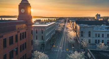 Traverse City showing a sunset, a city and landscape views