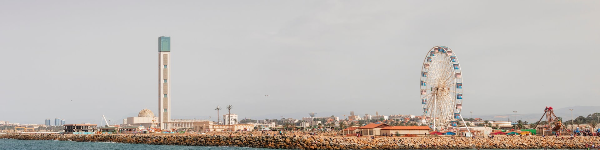 Algiers, panorama Cityscape for The Capital Of Algeria inculding Djamaa el Djazaïr also known as the Great Mosque of Algiers and sablette amusement park with the ferris wheel