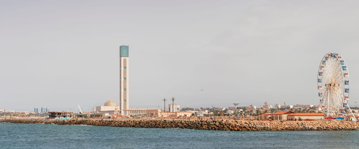Algiers, panorama Cityscape for The Capital Of Algeria inculding Djamaa el Djazaïr also known as the Great Mosque of Algiers and sablette amusement park with the ferris wheel