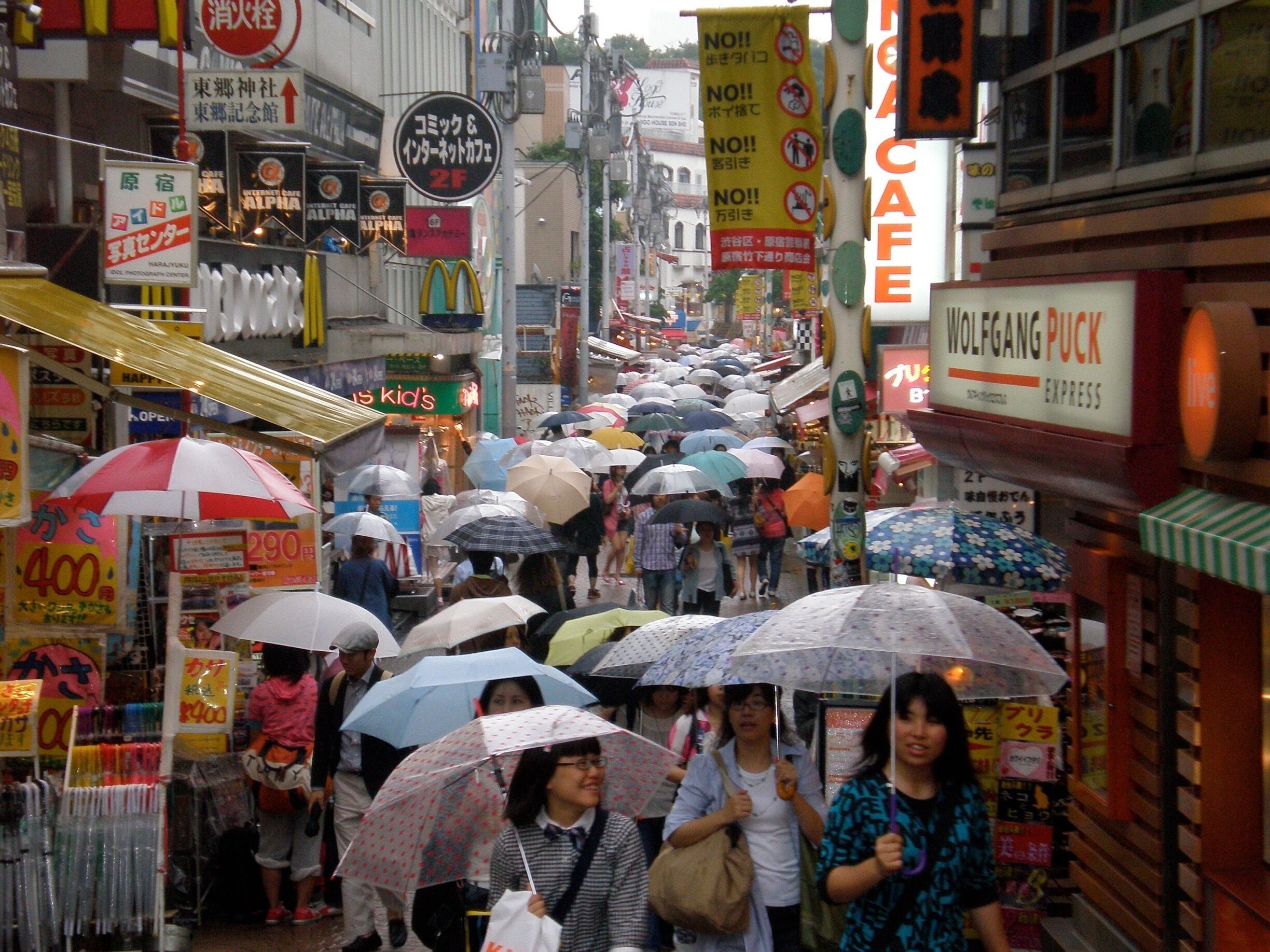 People in Tokyo don't let the rain stop them from doing their usual business.