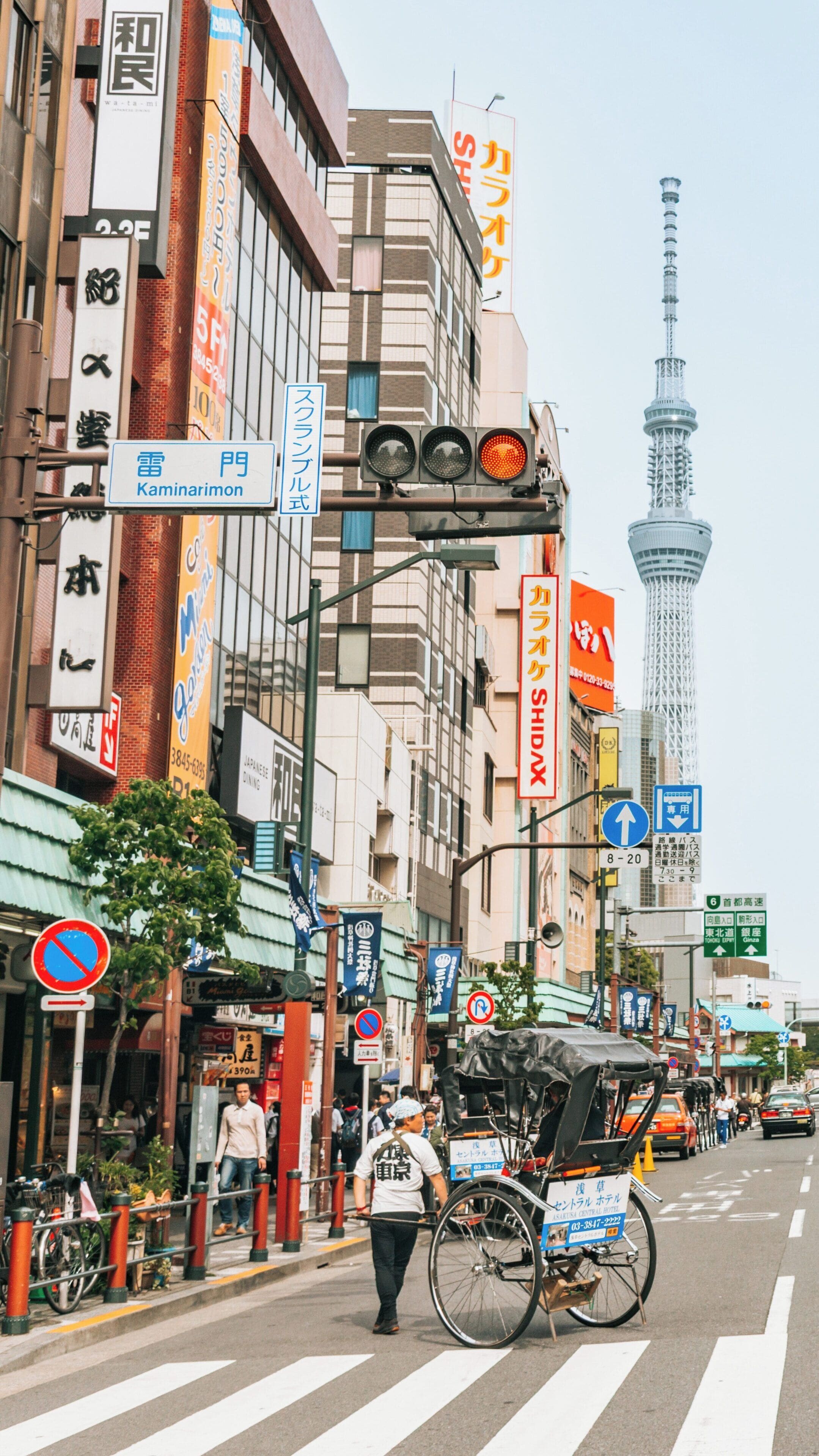 Exploring the vibrant streets of Sumida, Tokyo with the iconic Tokyo Skytree towering above in the distance