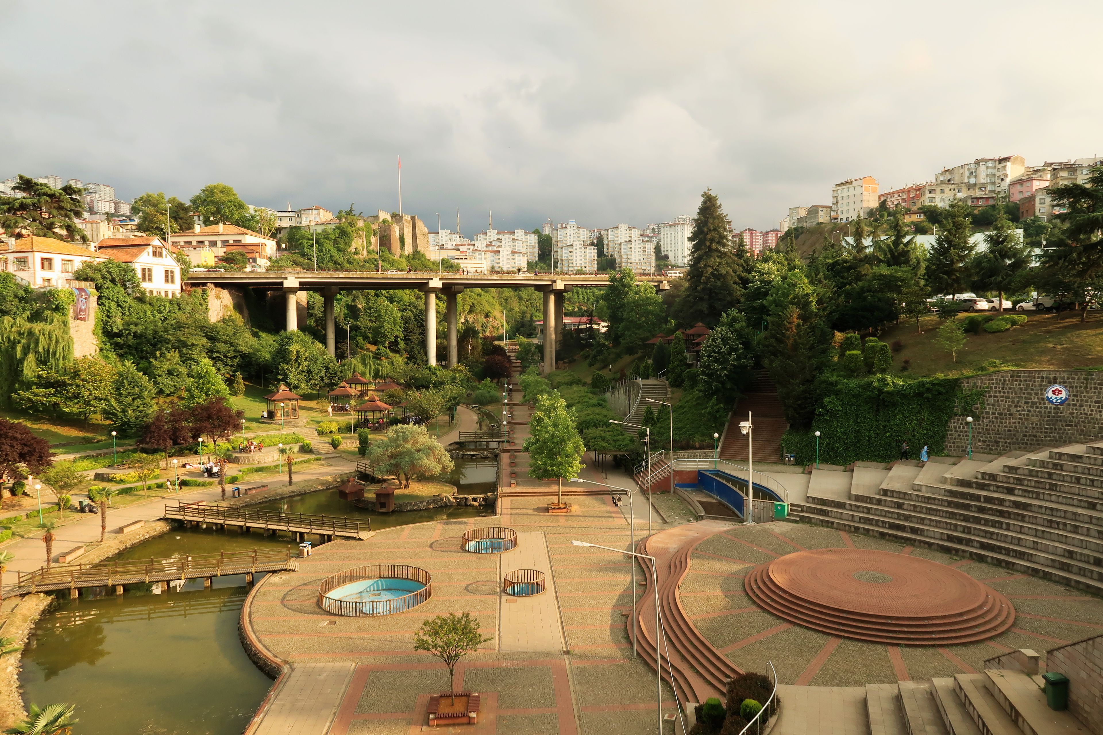 A park with a bridge, a pool, and a staircase.