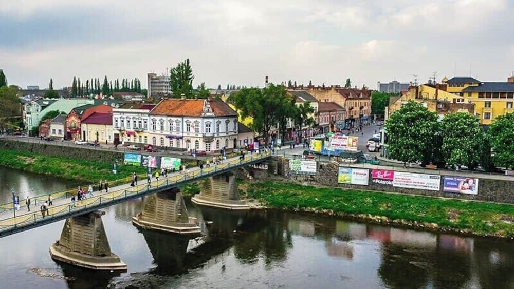 Pedestrian bridge across the river Uzh leads to Shandor Petefi square