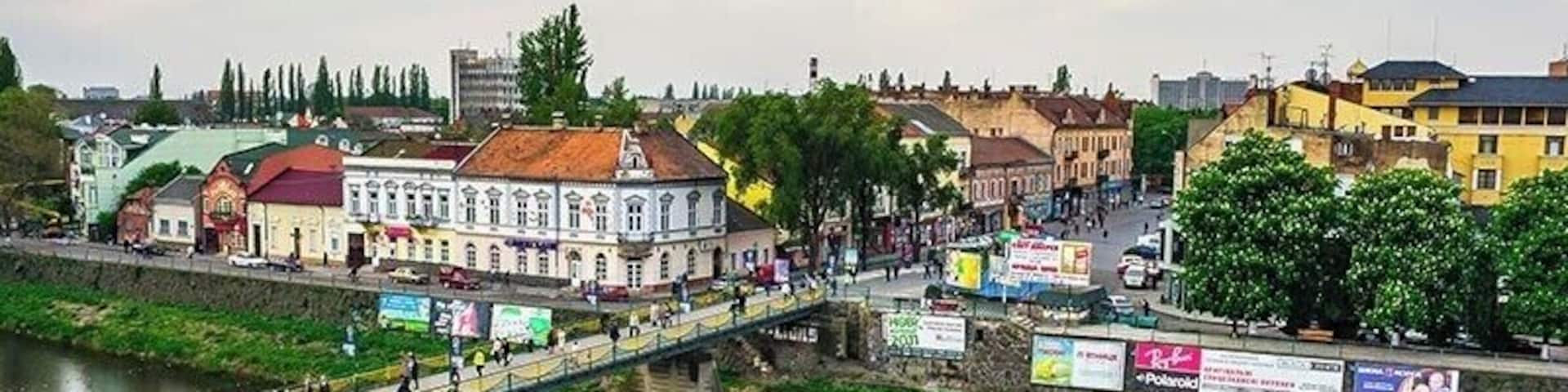 Pedestrian bridge across the river Uzh leads to Shandor Petefi square