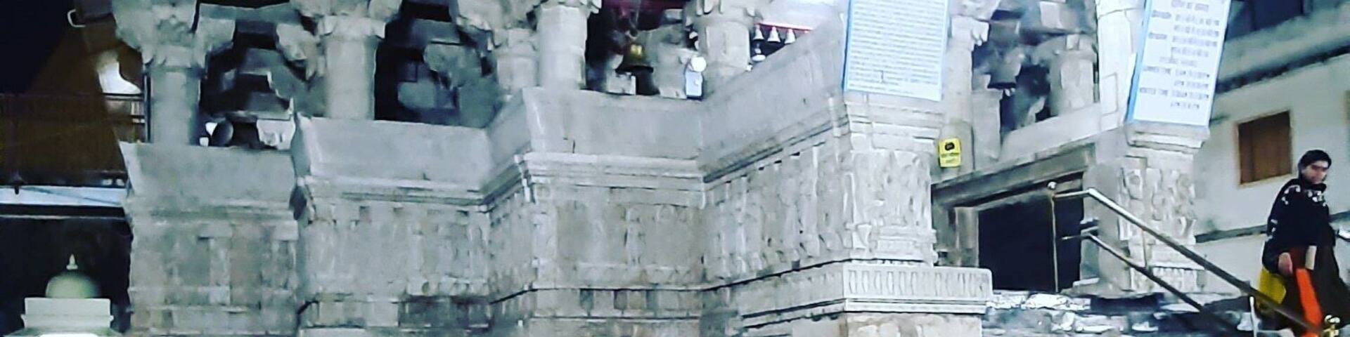 Jagdish Temple is one of the famous temples of Udaipur. Located in the City Palace complex of Udaipur, this temple is made in the Indo-Aryan style of architecture. In 1651, Jagdish temple was built by Maharana Jagat Singh, who ruled Udaipur during 1628-53. The temple is dedicated to Lord Vishnu (Laxmi Narayan), the preserver of the Universe. It is celebrated for being the largest temple in the city of Udaipur. The gateway of this temple can be sited at a distance of 150 meters from the Bara Pol of the City Palace.
This three-storied temple is a wonder of architecture that comprises beautifully carved pillars, decorated ceilings, painted walls and lush halls. In those times, 1.5 million rupees were spent to raise this structure. The spire of the main temple is around 79 feet high that undoubtedly dominates the skyline of Udaipur. This shikhar (spire) is festooned with sculptures of dancers, elephants, horsemen and musicians making it truly a sight to behold.
As and when you approach the temple, you will be welcomed by two huge stone elephants at the entrance. On the very front of the temple, you would find a stone slab that is imprinted with the inscriptions with reference to Maharaja Jagat Singh. To reach the main shrine, you have to take a marble flight of 32 steps. Here, you will find a brass image of Garuda, a figure of half-man and half-eagle. This huge idol stands as if; it is guarding the doorway of Lord Vishnu.