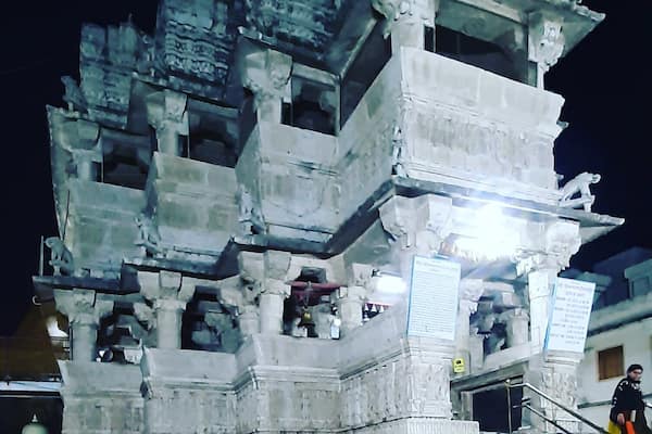 Jagdish Temple is one of the famous temples of Udaipur. Located in the City Palace complex of Udaipur, this temple is made in the Indo-Aryan style of architecture. In 1651, Jagdish temple was built by Maharana Jagat Singh, who ruled Udaipur during 1628-53. The temple is dedicated to Lord Vishnu (Laxmi Narayan), the preserver of the Universe. It is celebrated for being the largest temple in the city of Udaipur. The gateway of this temple can be sited at a distance of 150 meters from the Bara Pol of the City Palace.
This three-storied temple is a wonder of architecture that comprises beautifully carved pillars, decorated ceilings, painted walls and lush halls. In those times, 1.5 million rupees were spent to raise this structure. The spire of the main temple is around 79 feet high that undoubtedly dominates the skyline of Udaipur. This shikhar (spire) is festooned with sculptures of dancers, elephants, horsemen and musicians making it truly a sight to behold.
As and when you approach the temple, you will be welcomed by two huge stone elephants at the entrance. On the very front of the temple, you would find a stone slab that is imprinted with the inscriptions with reference to Maharaja Jagat Singh. To reach the main shrine, you have to take a marble flight of 32 steps. Here, you will find a brass image of Garuda, a figure of half-man and half-eagle. This huge idol stands as if; it is guarding the doorway of Lord Vishnu.