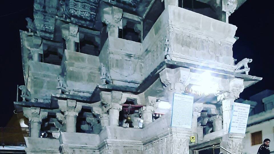 Jagdish Temple is one of the famous temples of Udaipur. Located in the City Palace complex of Udaipur, this temple is made in the Indo-Aryan style of architecture. In 1651, Jagdish temple was built by Maharana Jagat Singh, who ruled Udaipur during 1628-53. The temple is dedicated to Lord Vishnu (Laxmi Narayan), the preserver of the Universe. It is celebrated for being the largest temple in the city of Udaipur. The gateway of this temple can be sited at a distance of 150 meters from the Bara Pol of the City Palace.
This three-storied temple is a wonder of architecture that comprises beautifully carved pillars, decorated ceilings, painted walls and lush halls. In those times, 1.5 million rupees were spent to raise this structure. The spire of the main temple is around 79 feet high that undoubtedly dominates the skyline of Udaipur. This shikhar (spire) is festooned with sculptures of dancers, elephants, horsemen and musicians making it truly a sight to behold.
As and when you approach the temple, you will be welcomed by two huge stone elephants at the entrance. On the very front of the temple, you would find a stone slab that is imprinted with the inscriptions with reference to Maharaja Jagat Singh. To reach the main shrine, you have to take a marble flight of 32 steps. Here, you will find a brass image of Garuda, a figure of half-man and half-eagle. This huge idol stands as if; it is guarding the doorway of Lord Vishnu.