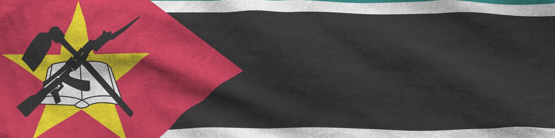 Mozambique flag depicted on folded wavy fabric of old cloth close up