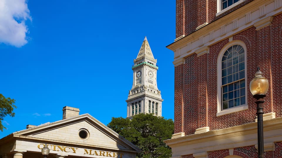 A historic building with a clock tower and the sign "CINCY MARKET" in front.