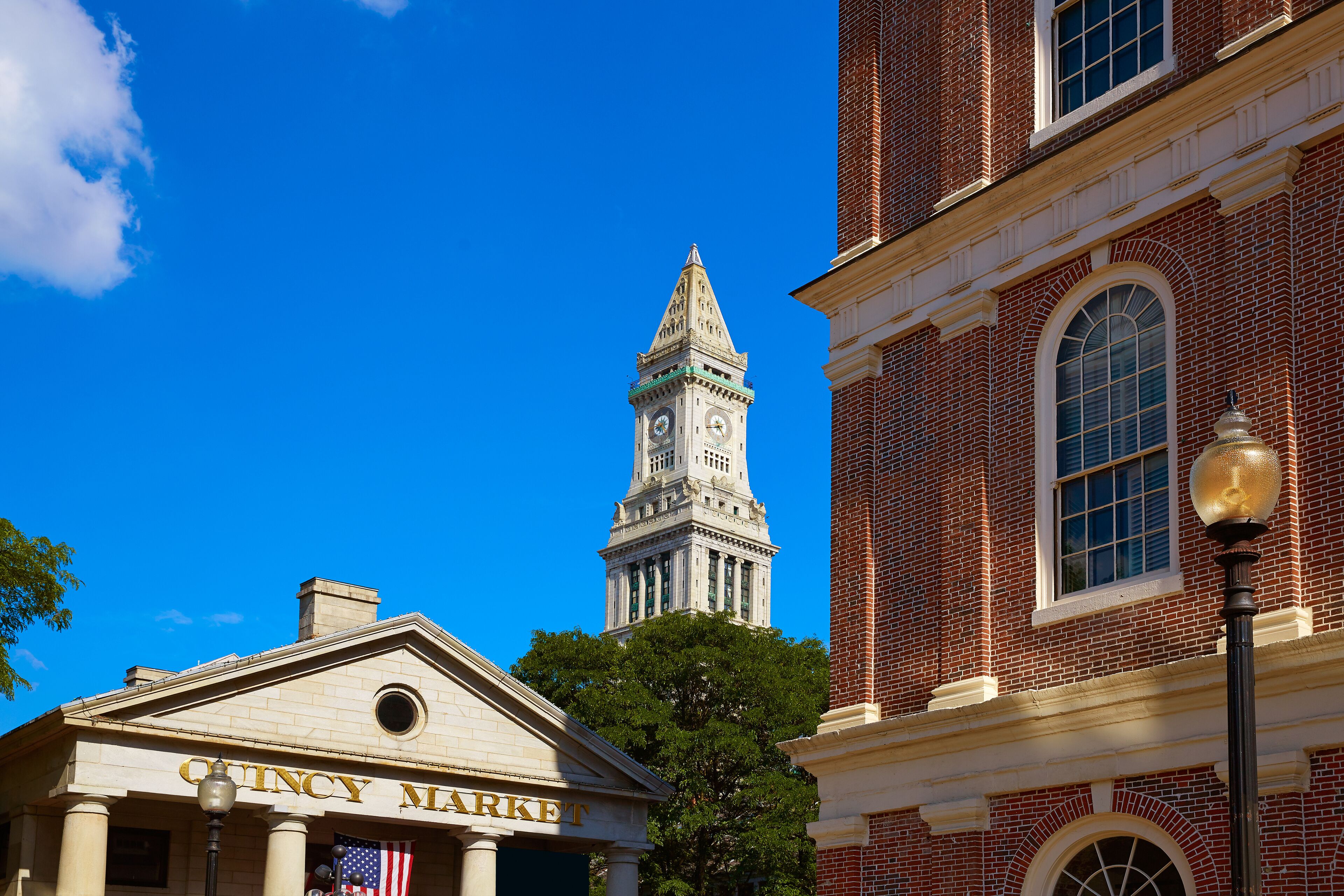 A historic building with a clock tower and the sign "CINCY MARKET" in front.