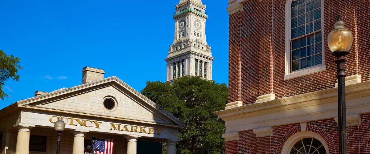 A historic building with a clock tower and the sign "CINCY MARKET" in front.